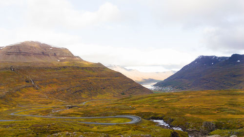 Scenic view of mountains against cloudy sky