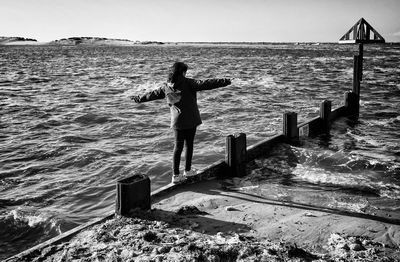 Woman balancing on beach