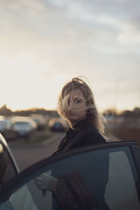 Side view of woman looking through window