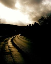 View of road against cloudy sky at sunset