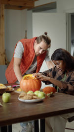 Side view of young woman preparing food at home