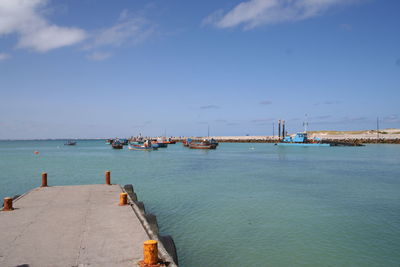 Boats in sea against sky