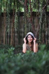 Portrait of smiling woman in forest