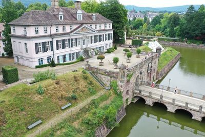 High angle view of river amidst buildings and trees