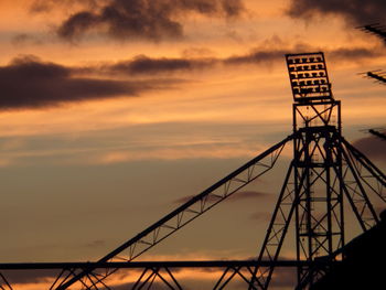 Low angle view of silhouette built structure against sky