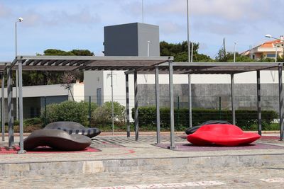 Red umbrella on street against buildings in city