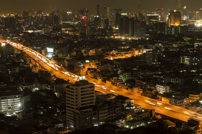 High angle view of illuminated city buildings at night