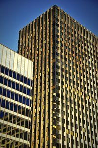 Low angle view of modern building against clear sky