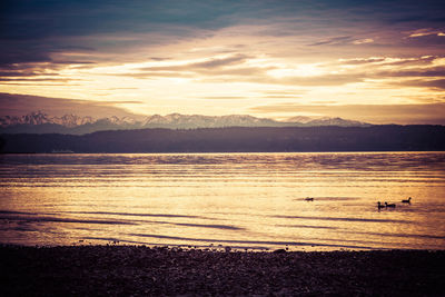 Scenic view of lake against sky during sunset