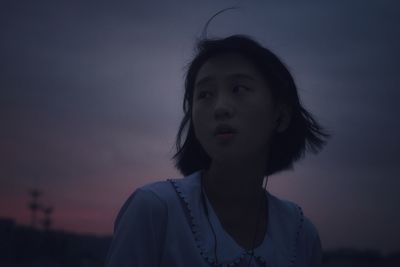 Young woman standing against clear sky