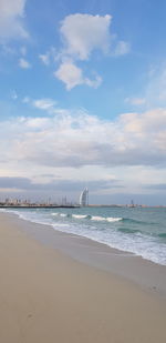 Scenic view of beach against sky with burj al arab hotel in the backdrop