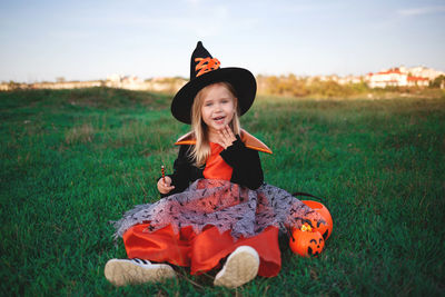 Portrait of girl sitting on field