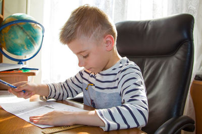 Boy sitting on table