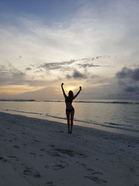 Rear view of man standing on beach