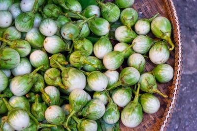 Directly above shot of eggplants in wicker basket for sale at market stall