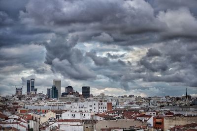 High angle view of cityscape against storm clouds