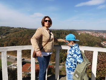 Portrait of mother with son standing at observation point