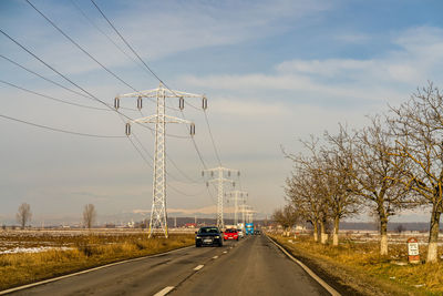 Road amidst trees against sky