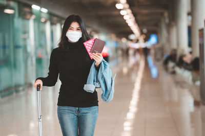 Portrait of woman standing at railroad station