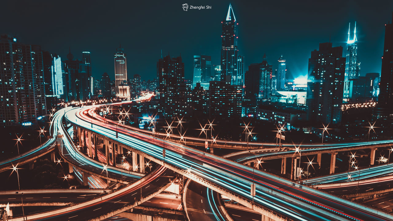 HIGH ANGLE VIEW OF ILLUMINATED CITY AT NIGHT