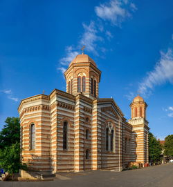 Low angle view of historic building against blue sky