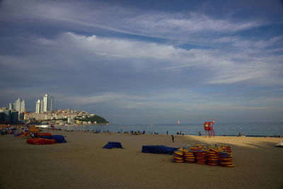 Inflatable rings at beach against sky