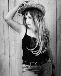 Portrait of woman wearing hat standing outdoors