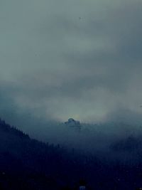 Scenic view of mountains against sky at night