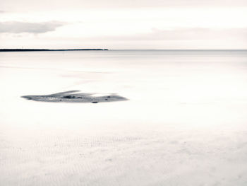 Scenic view of sea against sky during winter