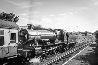 Train on railroad tracks against sky