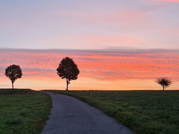 Scenic view of field against sky during sunset