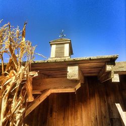 Low angle view of building against clear blue sky