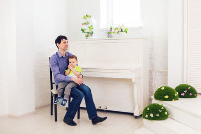 Full length of mother and daughter sitting on floor