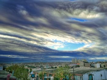 Houses in town against sky