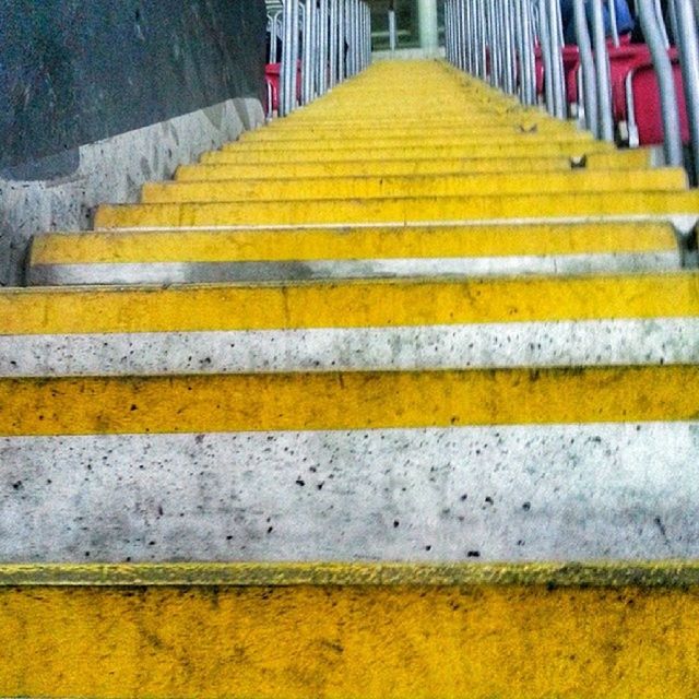 yellow, the way forward, striped, steps, pattern, multi colored, in a row, diminishing perspective, railing, steps and staircases, high angle view, day, outdoors, no people, close-up, street, road marking, wood - material, staircase, empty