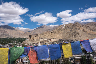 Low section of woman standing on mountain against sky