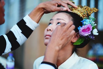 Artist applying make-up on young woman