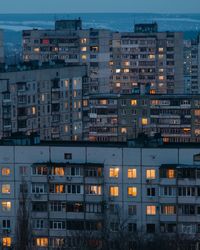 High angle view of illuminated buildings in city at dusk