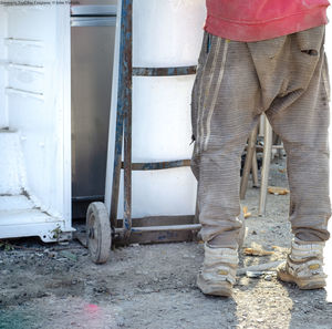 Low section of man standing on land