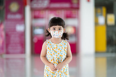 Portrait of cute girl standing outdoors