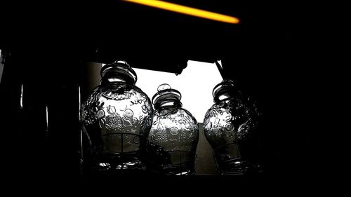 Close-up of electric lamp on table by window