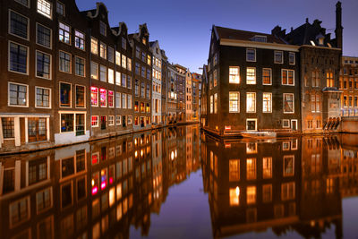 Reflection of buildings on water at dusk