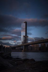 View of bridge over sea against cloudy sky