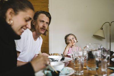 Portrait of friends sitting on table