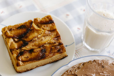 Delicious slice of homemade apple pie cake near a glass of milk