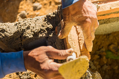 Close-up of human hand holding rock