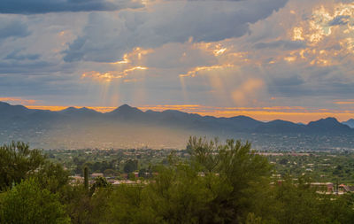 Panoramic shot of townscape against sky at sunset