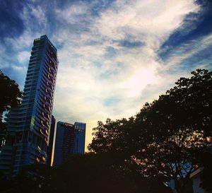 Low angle view of skyscrapers against sky during sunset