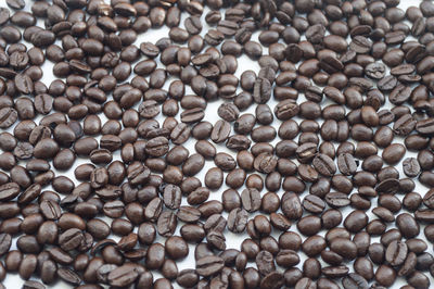 Full frame shot of roasted coffee beans on white background