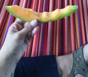 Midsection of woman holding fruit